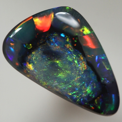 SOLID BLACK OPAL  Unusual pattern, nubular centre surrounded by rolling flashes